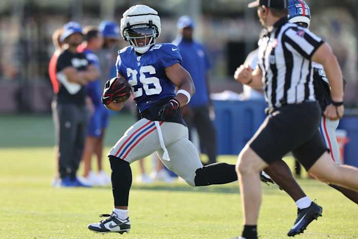 New York Giants running back Saquon Barkley carries the ball during practice.